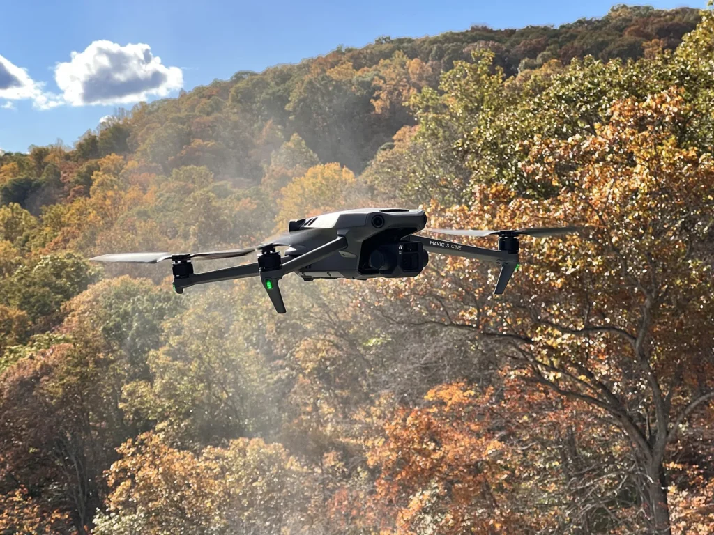 DJI Mavic 3 in volo davanti a un bosco in autunno